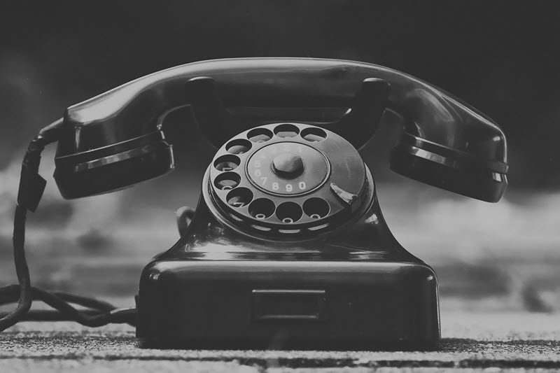 Old rotary dial black telephone.